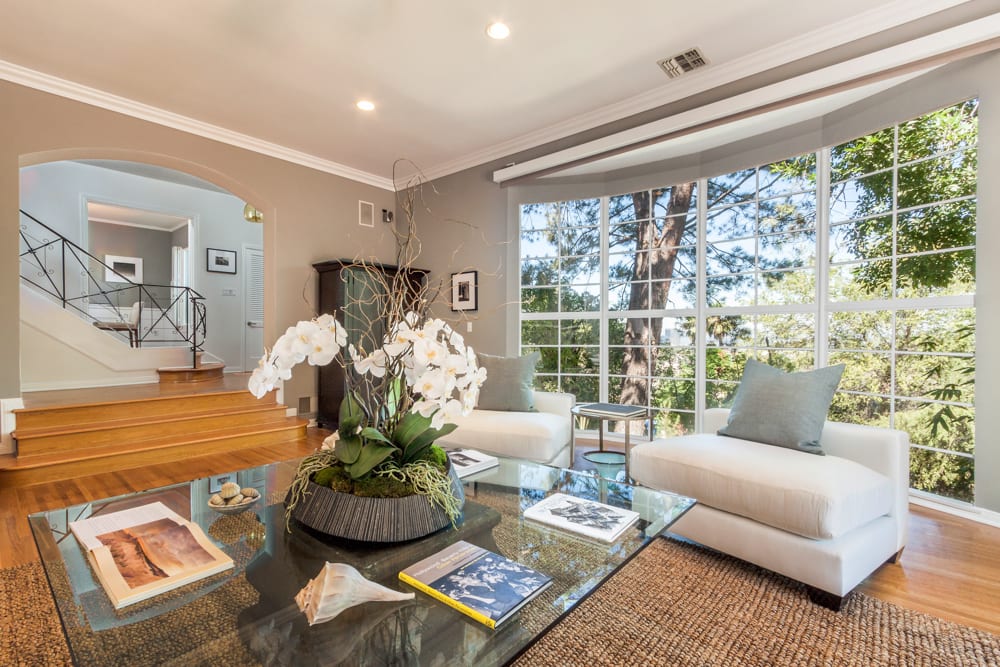A staged living room interior represented by Misraje Real Estate Partners